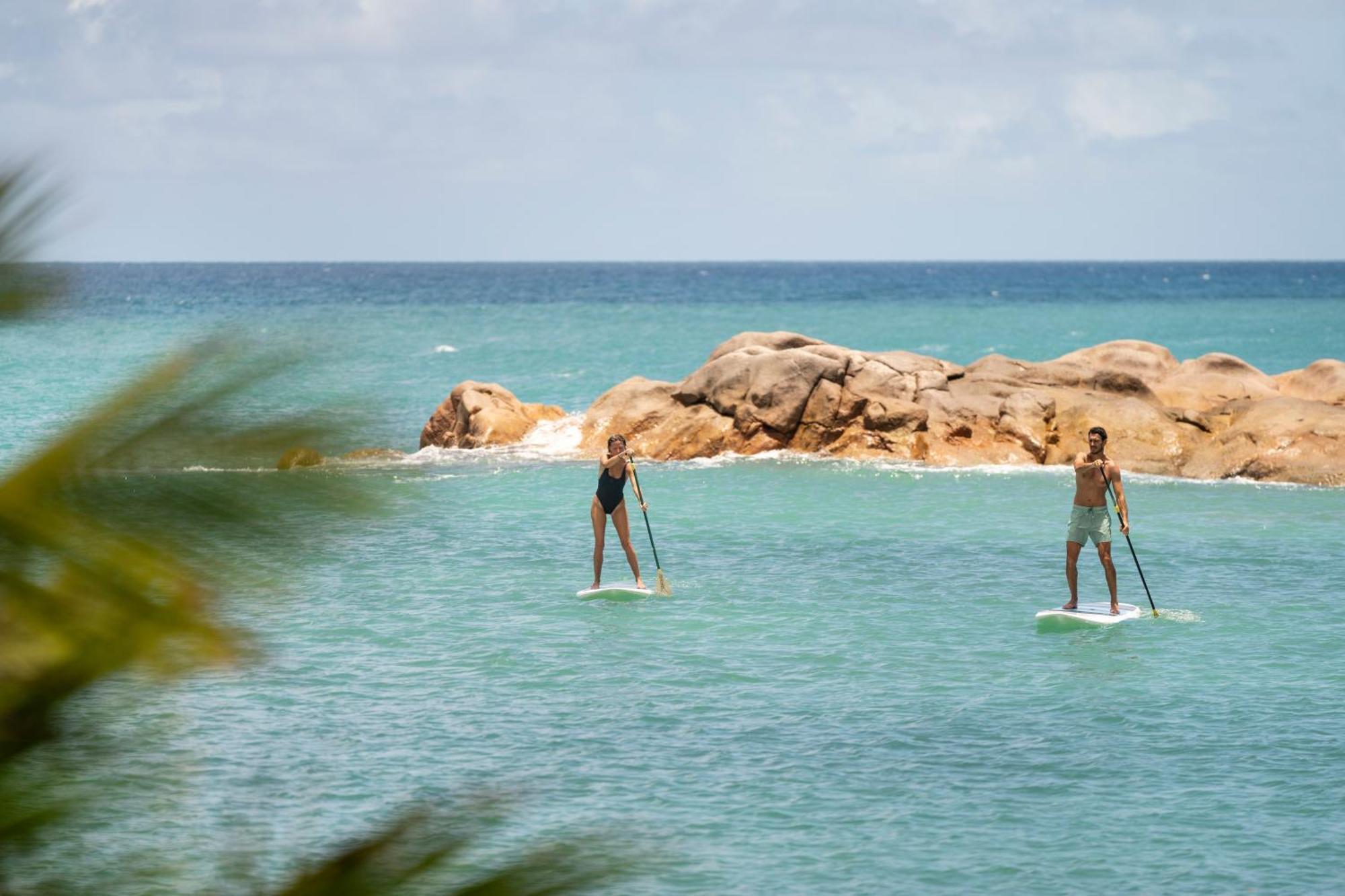 Constance Lemuria Grand Anse  Bagian luar foto Stand up paddle boarders on the bay